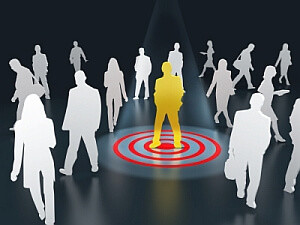 Target market - graphic of person standing on target bullseye surrounded by other people.